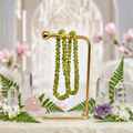 Peridot bracelets in a crystal garden with white orchids and ferns