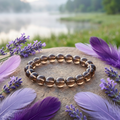 Smoky Quartz bracelet beside a misty lake with lavender and purple feathers