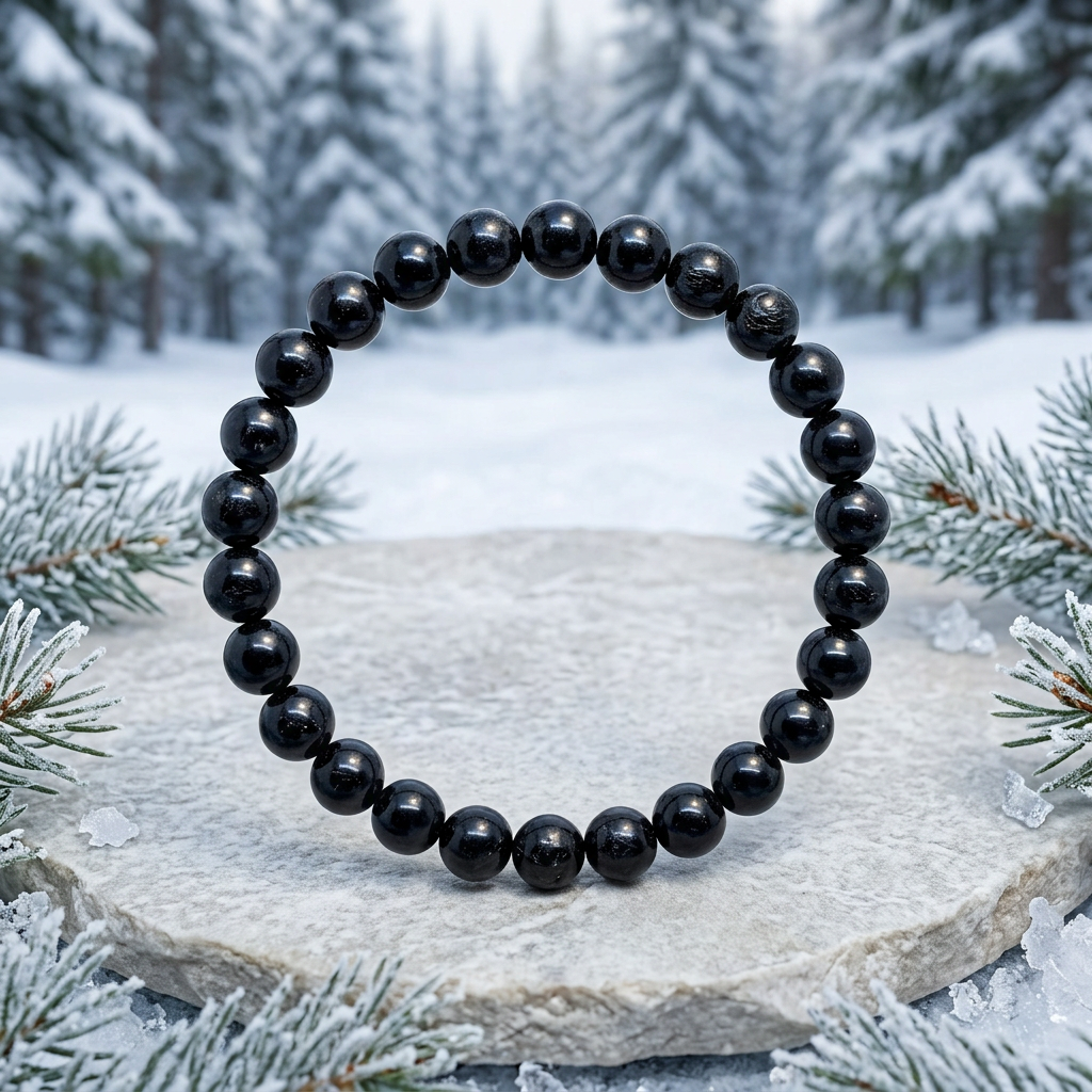 Black Tourmaline bracelet with snowy evergreen forest background