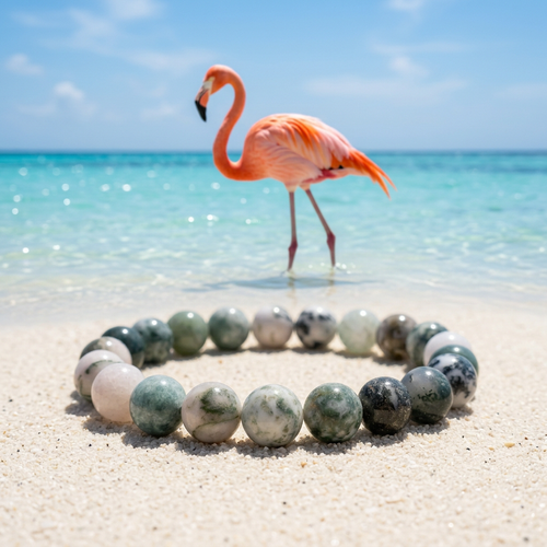 Bracelet on a sunny beach with pink flamingos beside a lagoon